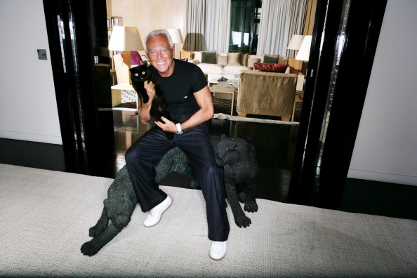 (Premium Pricing - DOUBLE RATES APPLY) Attitude by Giorgio Armani smiling, sitting on two sculptures representing felines, holding her cat in her arms, in his apartment in Milan, via Borgonuovo. (Photo by Sebastien Micke/Paris Match via Getty Images)